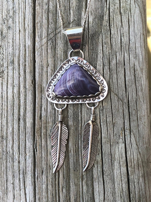 Wampum pendant with feathers.