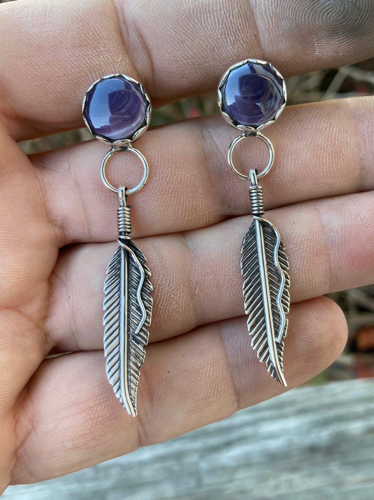 Wampam post feather earrings.