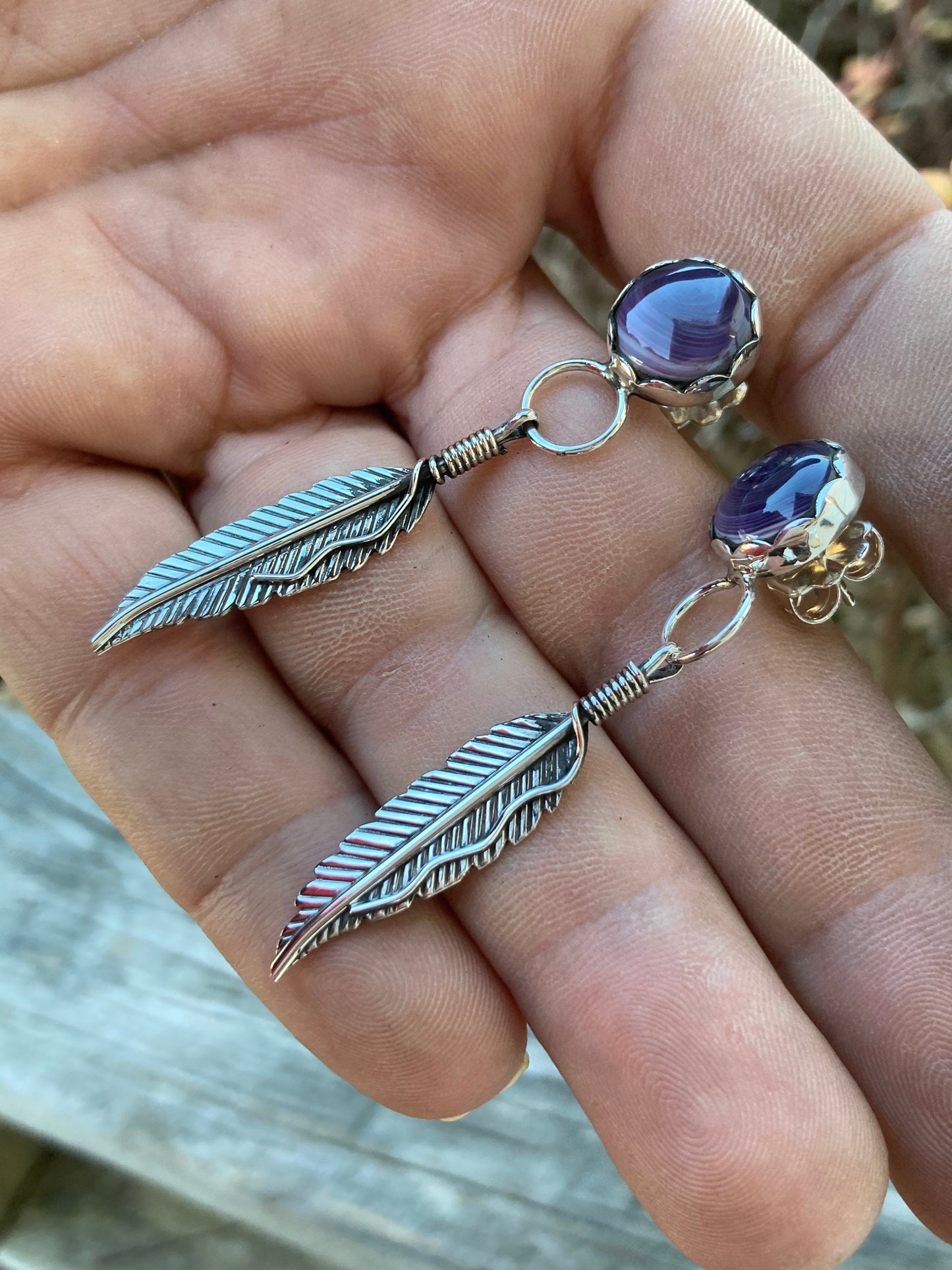 Wampam post feather earrings.